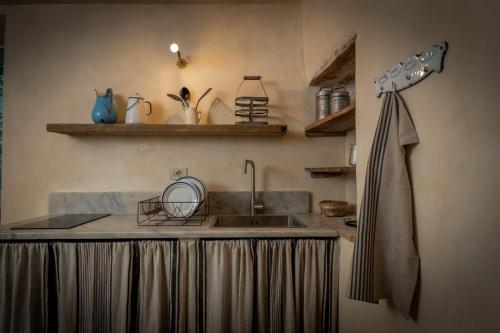 a kitchen with a sink and a counter top at L'imbrunire in Campiglia dʼOrcia