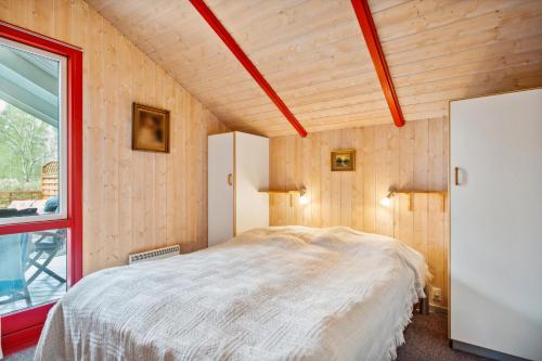 a bedroom with a bed in a room with a window at Charming And Cozy House Close To Ebeltoft in Ebeltoft