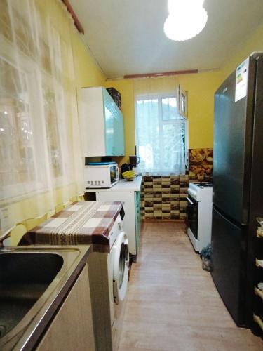 a kitchen with a sink and a refrigerator at Hostel 555 by VL in Alaverdi