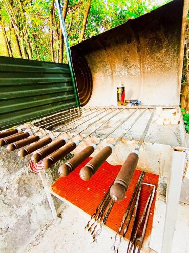 a grill with tongs and other cooking equipment on it at Hostel 555 by VL in Alaverdi