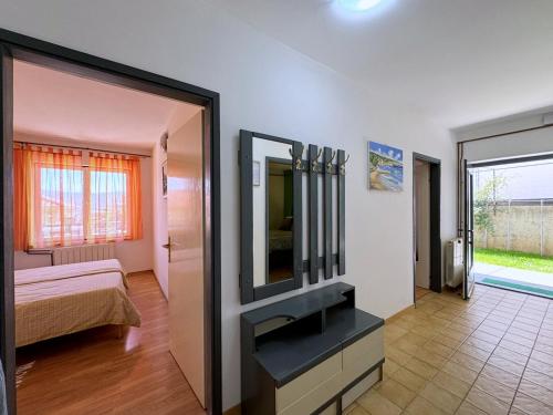 a bedroom with a mirror and a bed in a room at Apartments Andelka G in Šilo