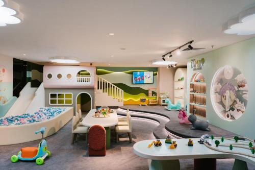 a childs playroom with a slide and a play room at The Westin Surabaya in Surabaya