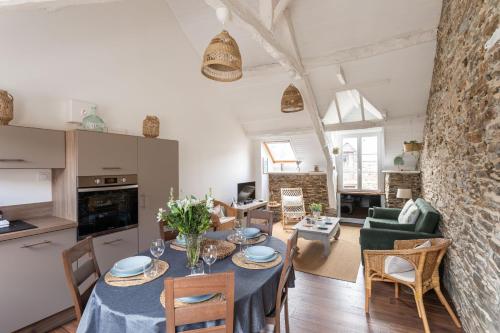 une cuisine et un salon avec une table et des chaises dans l'établissement Rêve Emeraude - 100m de la Plage, à Cancale