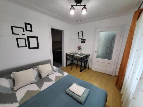 a bedroom with a bed and a table in it at Tulipan Hotel Aquapark in Vyshkove