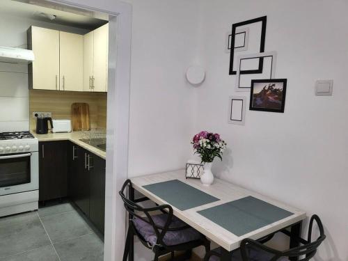 a kitchen with a table with chairs and a table at Tulipan Hotel Aquapark in Vyshkove