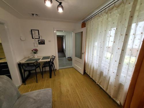 a living room with a table and a window at Tulipan Hotel Aquapark in Vyshkove