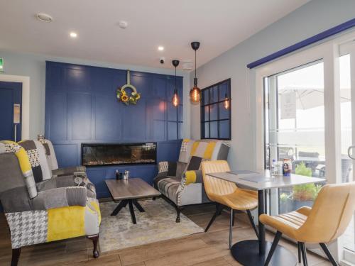 a living room with a couch and a fireplace at Number 1 Dome in Doirí Beaga