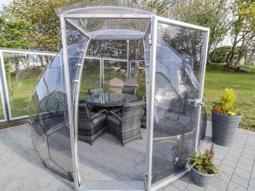 a greenhouse with a table inside of it at Number 1 Dome in Doirí Beaga