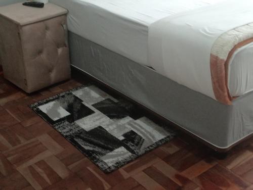 a bed frame with a rug under a bed at Moonlight Guesthouse - Boksburg in Boksburg