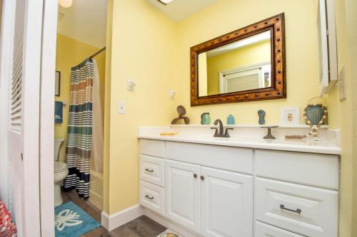 a bathroom with a sink and a mirror at Driftwood Landing 16 in Naples