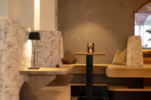 a living room with a couch and a table at Hotel Burggräflerhof in Merano