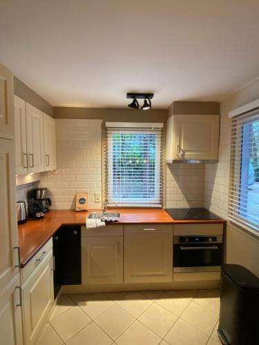 a kitchen with white cabinets and a counter top at 't Eekhoornnest in Soest