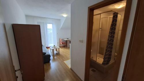 a hallway with a door to a living room at Apartments Mato with balconies, garden & the sea view in Seget Vranjica