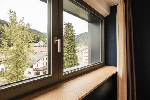a window with a view of a mountain at The Post Mountain Residence in Dobbiaco