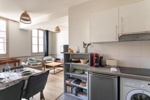 une cuisine et un salon avec une table et des chaises dans l'établissement Le Bas des Lices - Joli T2 à Rennes, à Rennes