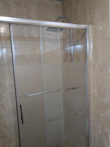 a shower with a glass door in a bathroom at Albergue Nido de Cigüeña in Nájera
