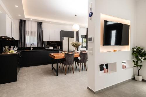 a kitchen and dining room with a table and chairs at Artemis Villa in Lithakia