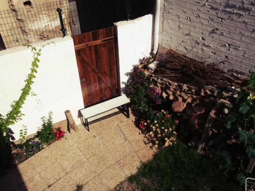a bench sitting in front of a building with flowers at Albergue Nido de Cigüeña in Nájera