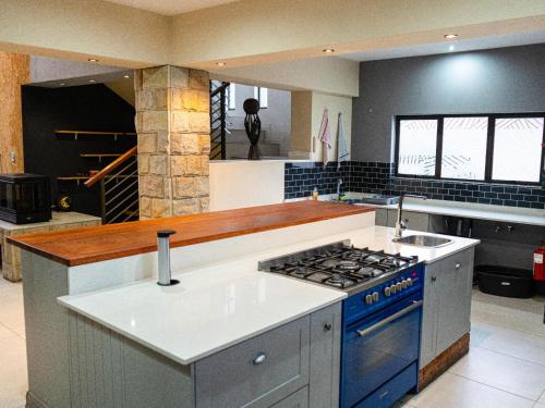 a kitchen with a stove and a blue oven at Soweto Boutique Hotel in Soweto