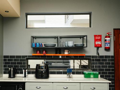 a kitchen with a sink and a counter top at Soweto Boutique Hotel in Soweto