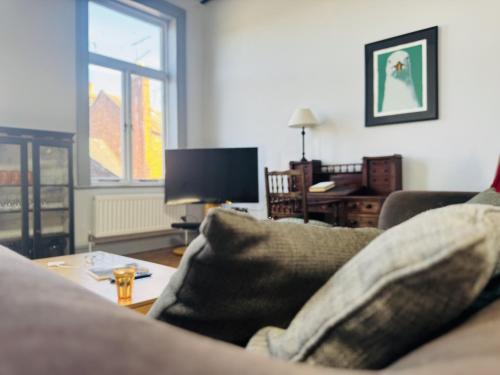 a living room with a couch and a table at High Living in Carlisle