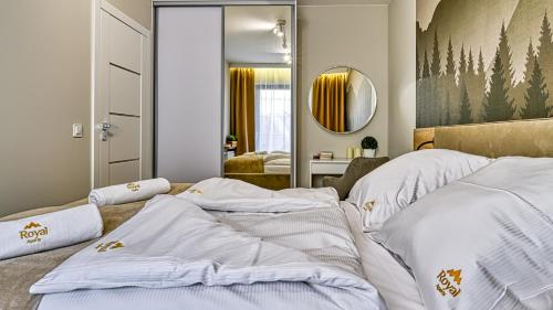 two beds in a room with a mirror at Źródło Izery przy gondoli VIP Sauna, Siłownia, Bawialnia by Royal Aparts in Świeradów-Zdrój