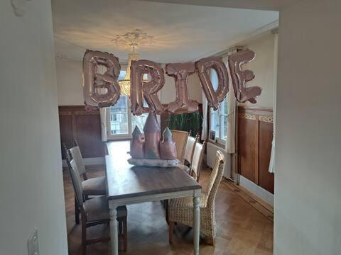 a dining room table with a sign that says sister at VILLA Turmmattli in Sarnen