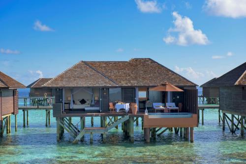 a house on a pier in the water at Lily Beach Resort and Spa - All Inclusive in Dhangethi