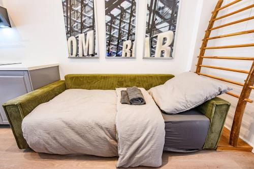 a couch with a blanket on it in a room at Cozy Lofts Next To Berliner Wall in Berlin