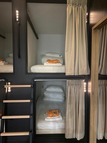 a room with two bunk beds and a mirror at guest house B in Osaka