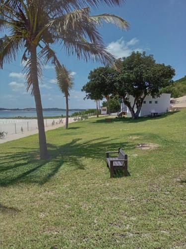 a park with a bench and palm trees on the beach at Blackstone Sands Resort Bilene in Vila Praia Do Bilene