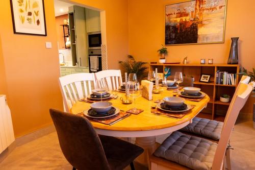 a dining room with a table with chairs and a dining room at Sarahs Home Away from Home Luxury Apartment in Ennis