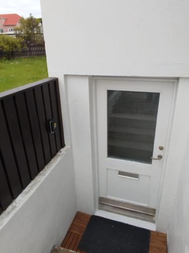 a door with a window next to a balcony at megiiceland in Njarðvík