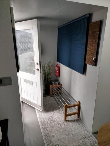 a room with a door and a bench and a window at megiiceland in Njarðvík