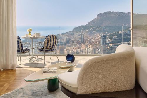 a living room with a view of the city at The Maybourne Riviera, Maybourne in Roquebrune-Cap-Martin