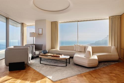 a living room with a couch and a table at The Maybourne Riviera, Maybourne in Roquebrune-Cap-Martin