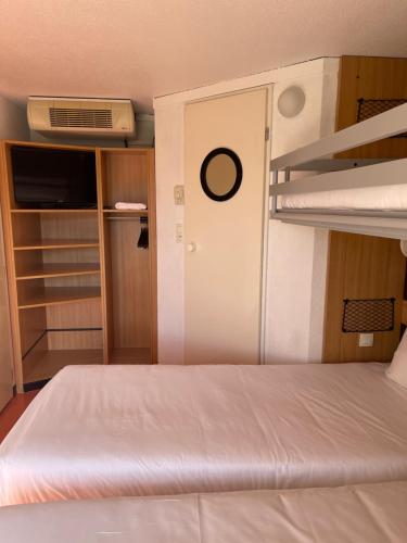 a bedroom with a bed and a bunk bed at Premiere Classe Amiens Est - Glisy in Glisy