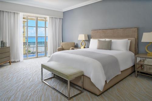 a bedroom with a large bed and a balcony at Kempinski Hotel Cancun in Cancún