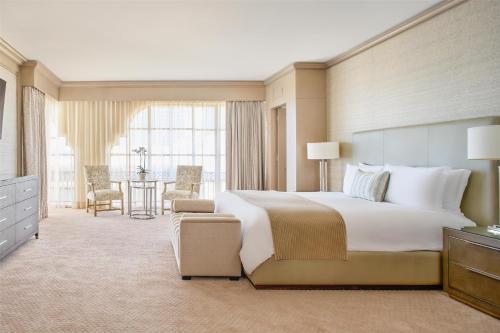 a large bedroom with a large bed and a table at Kempinski Hotel Cancun in Cancún
