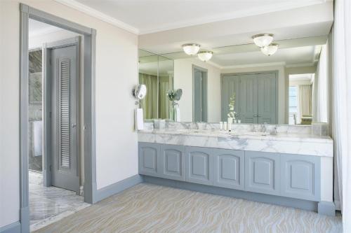 a bathroom with a large sink and a large mirror at Kempinski Hotel Cancun in Cancún
