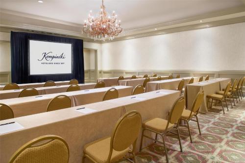 a conference room with tables and chairs and a screen at Kempinski Hotel Cancun in Cancún
