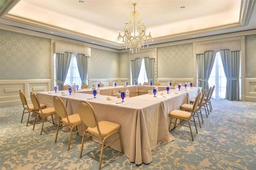 a long table in a room with chairs and a chandelier at Kempinski Hotel Cancun in Cancún