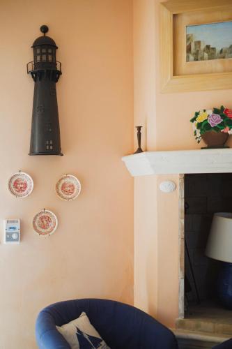 a room with a fireplace with a lighthouse on the wall at Casa a *POLIGNANO* con [Affaccio sul Mare] in Polignano a Mare