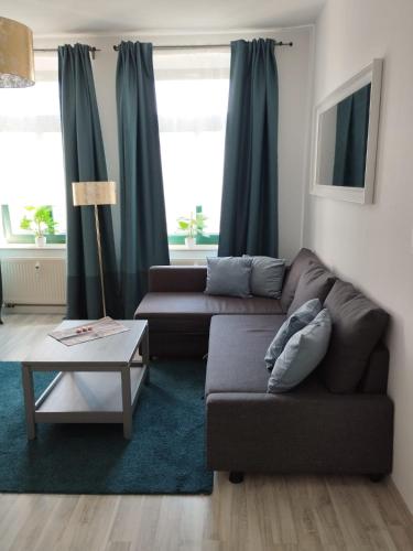 una sala de estar con un sofá y una mesa en Mikra Homes24 in Chemnitz, en Chemnitz