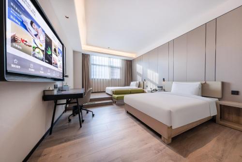Ένα ή περισσότερα κρεβάτια σε δωμάτιο στο Atour Hotel Xian Greater Wild Goose Pagoda