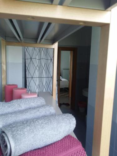 a bedroom with two beds with pink and white sheets at Palme e vigne in Offida