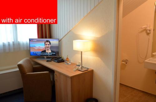 a room with a desk with a computer on it at Hotel Felmis in Luzern