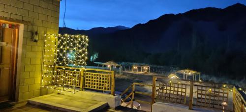 a building with lights on the outside of it at Devaranya Homestay in Leh