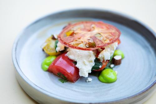 a plate with a sandwich with vegetables on it at Blakeney House in Blakeney