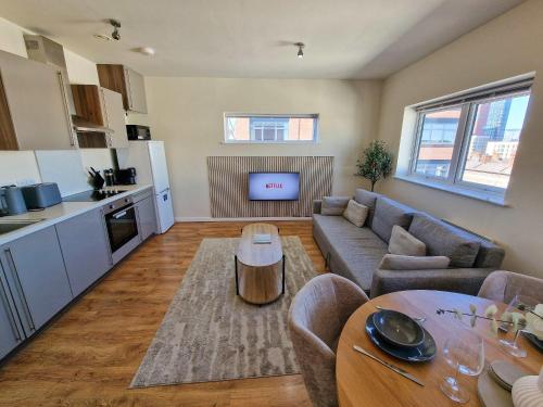a living room with a couch and a table at Free Parking City Centre Flat by City SuperHost in Manchester